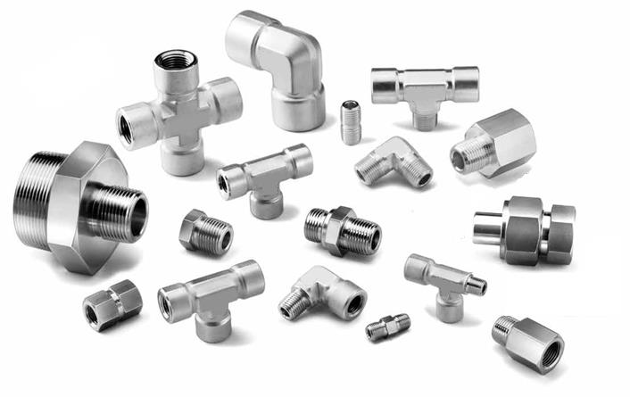 Assortment of stainless steel pipe fittings, including elbows, tees, crosses, nipples, and plugs.